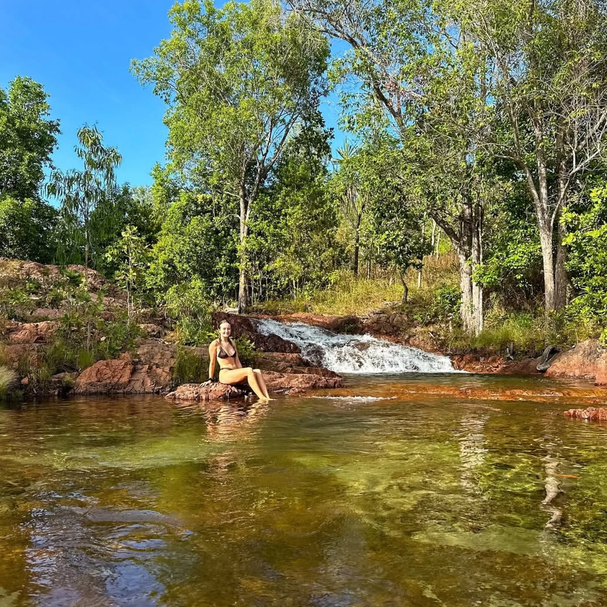 wangi falls with person enjoying view